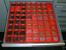 24" x 24" Tool Box Drawer divided by 3" x 3" Red Plastic Boxes