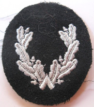 WW2 German Feuerwehr (Fire Police) Sleeve Insignia for an assistant Kreisleter (County Leader). A light grey machine embroidered wreath on a midnight blue wool oval. Worn on the lower left sleeve, this insignia denoted a position, not rank and was created during the war. 