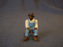 PAINTED PEWTER BLACK MAN SITTING ON STOOL IN OVERALLS O GAUGE