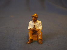PAINTED PEWTER BLACK MAN SITTING ON CRATE WITH DRINK O GAUGE