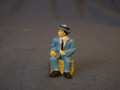 PAINTED PEWTER MAN SITTING ON CRATE O GAUGE