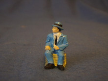 PAINTED PEWTER MAN SITTING ON CRATE O GAUGE