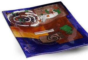 10 inch square blue glass platter featuring red and brown fused glass, touches of green and other colors and a white spiral