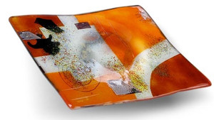 A 10 inch square bowled, decorative fused glass plate featuring orange, red and white with a combination of other color details