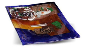 12" square fused glass platter featuring blue, yellow, red glass, with abstract designs, appliqued objects and a white spiral