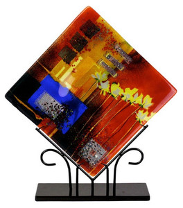 A beautiful multi colored fused art glass platter presented in a diamond shape