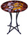 Geometric patterns in black yellow and red are the backdrop for the leaves on this fused glass cafe table
