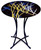 This round fused glass cafe table features a muted black and blue geometric background, with artful strokes of white and gold representing the wind