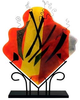 A decorative fused glass panel, in a diamond shape, with many bold colors, including red and yellow.  Abstract.  Stand included.