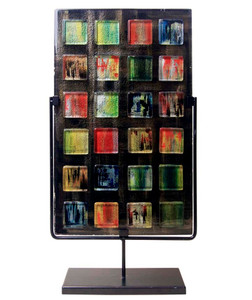 A tall, rectangular fused glass decorative panel featuring a number of small colored glass squares.  Stand included