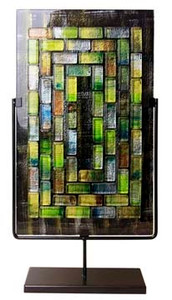 A tall, rectangular fused glass decorative panel featuring rectangular glass pieces in concentric patterns.  Stand included