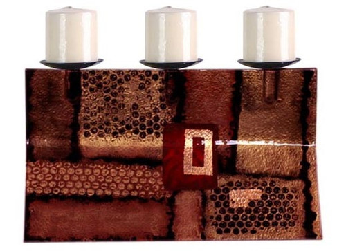 A triple candle holder in fused glass, featuring geometric shapes and perforated patterns.  Bronze, brown, gold