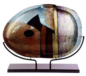 A 19in oval vase featuring brown, whte, blue, black, red and gold in an abstract contemporary pattern.  Stand included.