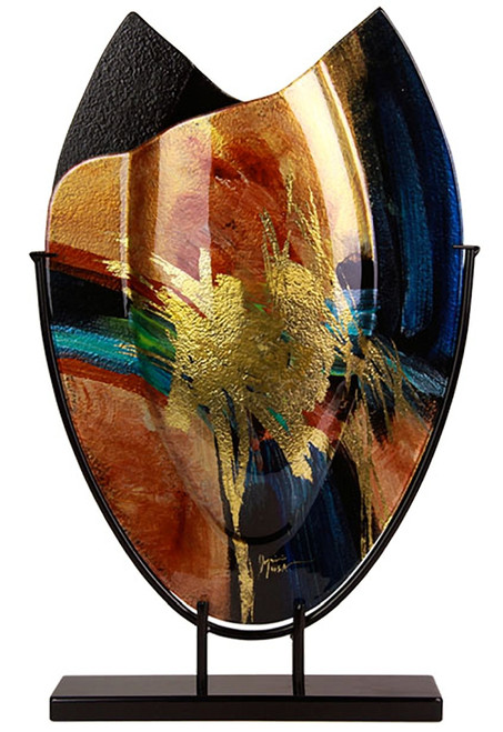 A beautiful oval shaped fused glass vase with blues, black, orange, red, green and gold.  Some hand painted details are included, as is the stand