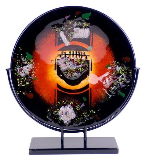 Round fused glass platter, featuring black, red and orange, with multiple collection of mesh screens and colors.  Stand included