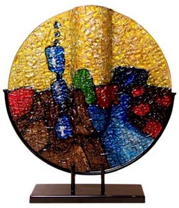 A round fused glass vase, with brown, gold stipple effect along with a variety of other bold colors.  Stand included.