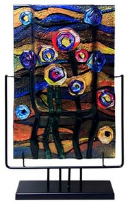 This 18-inch rectangular fused glass platter features blue, violet, green, black and yellow with hints of pink.  Abstract flowers, reminiscent of a starry night.   Stand included