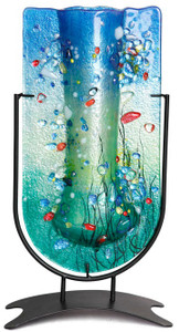 Marine colors are featured in this 14.5-inch tall U-shaped fused glass vase with blue and green, along with many other colored pieces fused in place.  Stand included