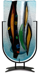 Aqua blue colors and leaf-like fronds in black, green and yellow are featured in this 18.5x10 fused glass vase. Metal stand included