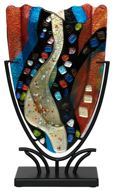 A small Fused Glass V Vase with rich colored vertical waving stripes in black, white red and blue, featuring multi colored glass pebbles and jewels fused in place. Stand included