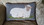 "Reposing Sheep" hooked by designer, Kathy Gaul.  Off the bolt felted wools used to hook this pillow, sized 16" x 10", finished without the word "Sheep" at bottom.  Canvas IS drawn with wording option for finished size of 16" x 12".