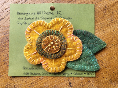 This gold and green flower pin is hand made by the designer!  