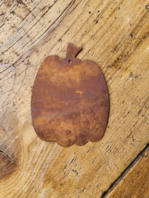 Rusty tin pumpkin with hang hole.