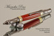 Handmade Ballpoint Pen made from Red and Orange TruStone with Gun Metal / Gold color finish.  Tip view of pen.