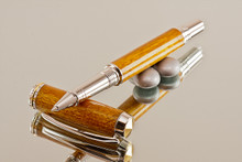 Handmade Rollerball made from Desert Ironwood with Chrome and Gold color accents. 