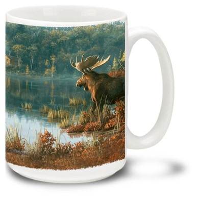 A beautiful Moose among a lake and trees.