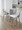Charlotte 24" Farmhouse Fixed-Height Counter Stool with Swivel in Light Grey Wood and Cream Fabric with Round Chrome Metal Footrest- Set of 2 — lifestyle photo 1