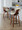 Curvini 24" Mid-Century Modern Fixed-Height Counter Stool with Swivel in Walnut Wood and Cream Fabric with Round Black Metal Footrest- Set of 2 — lifestyle photo 2