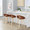 Grotto Upholstered 24" Contemporary Fixed-Height Counter Stool with Swivel in Natural Wood and Camel Faux Leather with Round Chrome Metal Footrest- Set of 2 — lifestyle photo 1