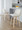 Toriano 24" Contemporary Fixed-Height Counter Stool with Swivel in Natural Wood and Cream Fabric with Round Chrome Metal Footrest- Set of 2 — lifestyle photo 3