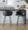 Claire counter stool in Black Metal, Gold Metal, Black PU, close-up detail, featuring swivel