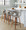Curva 26" Mid-Century Modern Fixed-Height Counter Stool with Swivel in Walnut Wood and Light Grey Faux Leather with Round Black Metal Footrest- Set of 2 — lifestyle photo 1