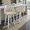 Dahlia 26" Contemporary Fixed-Height Counter Stool with Swivel in White Wood and Cream Faux Leather with Round Chrome Footrest- Set of 2 — lifestyle photo 2