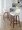 Daniella 26" Contemporary Fixed-Height Counter Stool with Swivel in Walnut Wood and Cream Fabric with Round Black Metal Footrest- Set of 2 — lifestyle photo 2