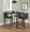 Fuji 26" Contemporary High Back Counter Stool in Black Steel and Black Faux Leather- Set of 3 — lifestyle photo 2