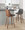 Gianna Mid-Century Modern Fixed-Height Counter Stool with Swivel in Walnut Wood and Grey Faux Leather with Square Chrome Metal Footrest- Set of 2 — lifestyle photo 2
