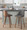 Gianna Mid-Century Modern Fixed-Height Counter Stool with Swivel in Walnut Wood and Grey Faux Leather with Square Chrome Metal Footrest- Set of 2 — lifestyle photo 3
