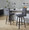 Hank 26" Contemporary Fixed-Height Counter Stool with Swivel in Walnut Glazed Wood and Black Fabric with Round Black Metal Footrest- Set of 2 — lifestyle photo 1