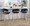 Jie Fixed-Height Contemporary Counter Stool with Swivel in Gold Metal and Black Faux Leather with Round Footrest- Set of 2 — lifestyle photo 1