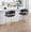 Jie Fixed-Height Contemporary Counter Stool with Swivel in Gold Metal and Black Faux Leather with Round Footrest- Set of 2 — lifestyle photo 3