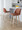 Toriano 26" Contemporary Fixed-Height Counter Stool with Swivel in Whitewashed Wood and Camel Faux Leather with Round Chrome Metal Footrest- Set of 2 — lifestyle photo 1
