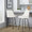Studded Marcel 27" Contemporary Fixed-Height Counter Stool with Swivel in Black Metal and White Faux Leather with Gold Nailhead Trim and Round Gold Metal Footrest- Set of 2 — lifestyle photo 1
