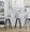 Ahoy Upholstered 30" Contemporary Fixed-Height Barstool with Swivel in Black Wood and Light Grey Fabric with Round Gold Metal Footrest- Set of 2 — lifestyle photo 2