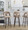 Ava Upholstered 30" Contemporary Fixed-Height Barstool with Swivel in Walnut Glazed Wood and Taupe Velvet with Round Black Metal Footrest- Set of 2 — lifestyle photo 1