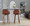 Dahlia 30" Contemporary Fixed-Height Barstool in Walnut Wood and Camel Faux Leather with Round Chrome Footrest- Set of 2 — lifestyle photo 2