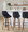 Diana bar stool in Walnut Wood, Black PU, Black Metal, featuring swivel and wood frame
